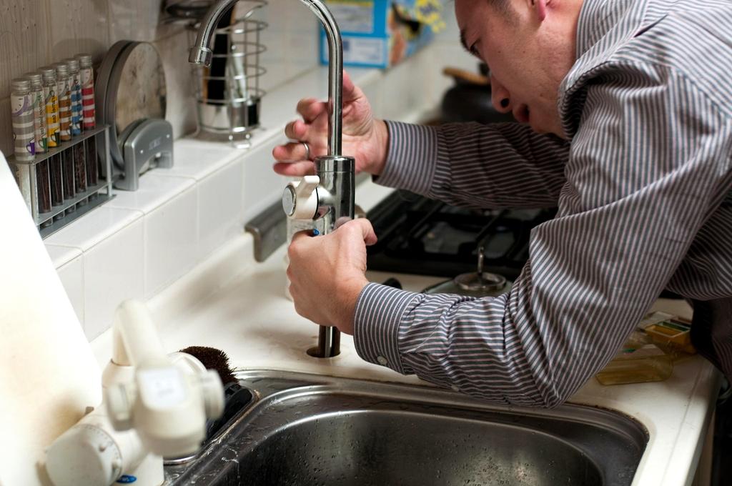 Technician installing a wall-mounted air conditioning unit
